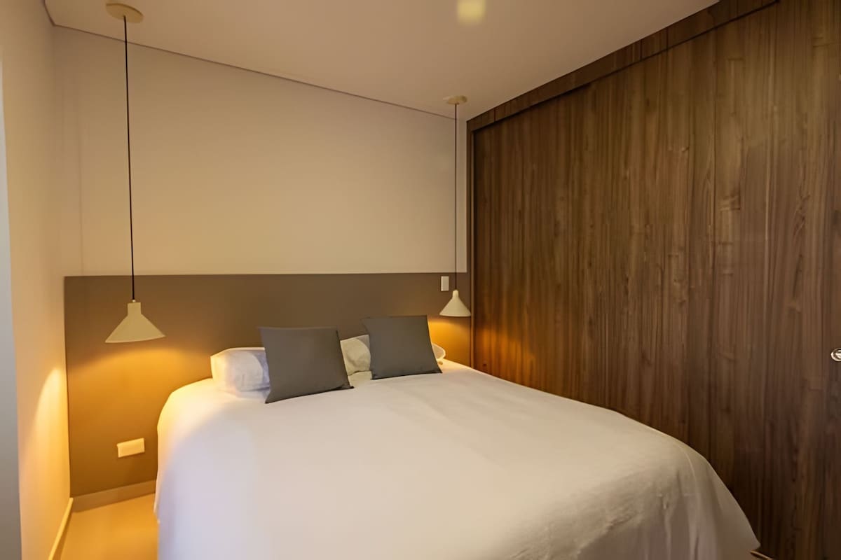 Bedroom 3 features a comfortable Double bed, a cozy room with a portable air conditioner, a table lamp, offering comfort and privacy.