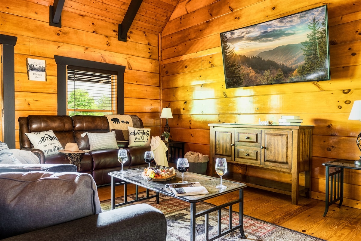 Heading back inside, you'll appreciate the cozy family room with the theater couch, queen-sized sleeper sofa and curved HD Smart TV. 