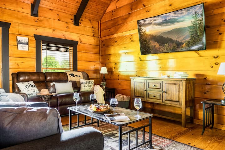 Heading back inside, you'll appreciate the cozy family room with the theater couch, queen-sized sleeper sofa and curved HD Smart TV. 