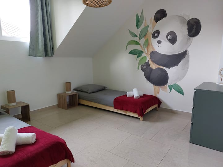A bedroom with 2 single beds 80x200cm that can be put one next to the other for couples