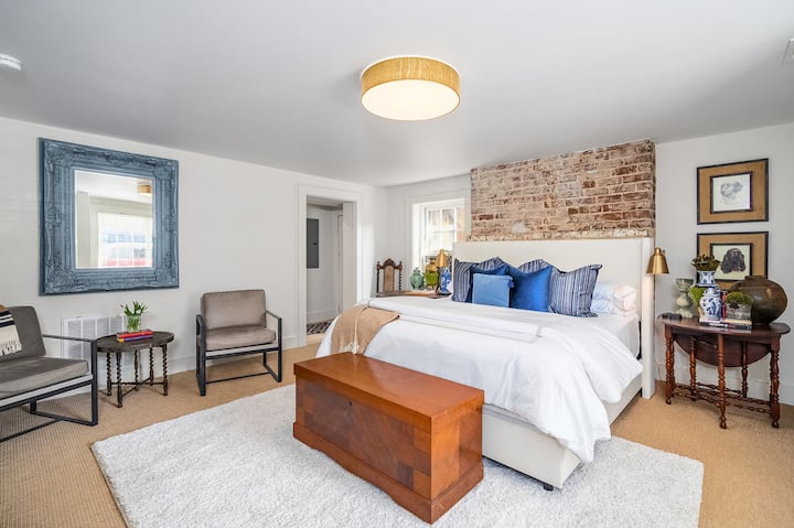 North Bedroom with a very comfortable, upholstered, king-size bed. Bedroom with an ensuite bathroom and laundry area. 