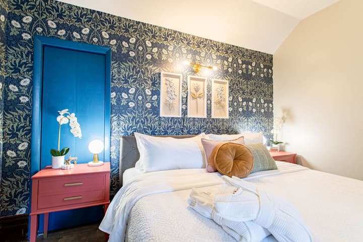 Serene bedroom with a relaxing view, offering plenty of natural light and a tranquil atmosphere for a peaceful stay.