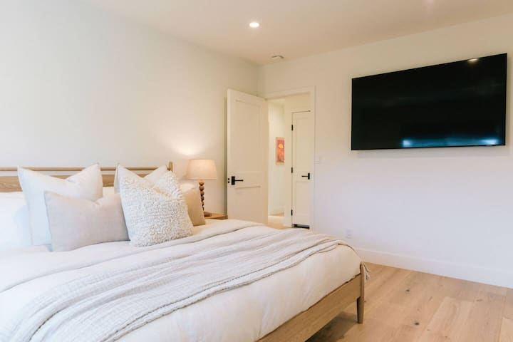 Primary bedroom has a king bed, and a 65" TV
