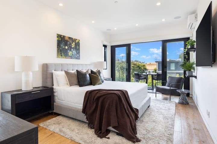 Welcome to your oversized primary bedroom. Dive into a plush king bed to watch some TV, or relax in your own indoor and outdoor seating areas.