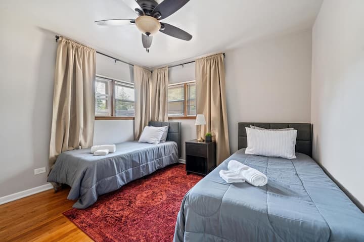 ห้องนอนอเนกประสงค์นี้มีเตียงเดี่ยวสองเตียงที่สะดวกสบาย เหมาะสำหรับเพื่อนหรือครอบครัว ช่วยให้หลับสบายตลอดทั้งคืน