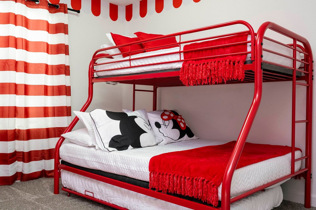 Kids will love this magical room! Featuring a Mickey & Minnie theme, a twin over full bunk bed, a single bed in a drawer, and a smart TV for entertainment