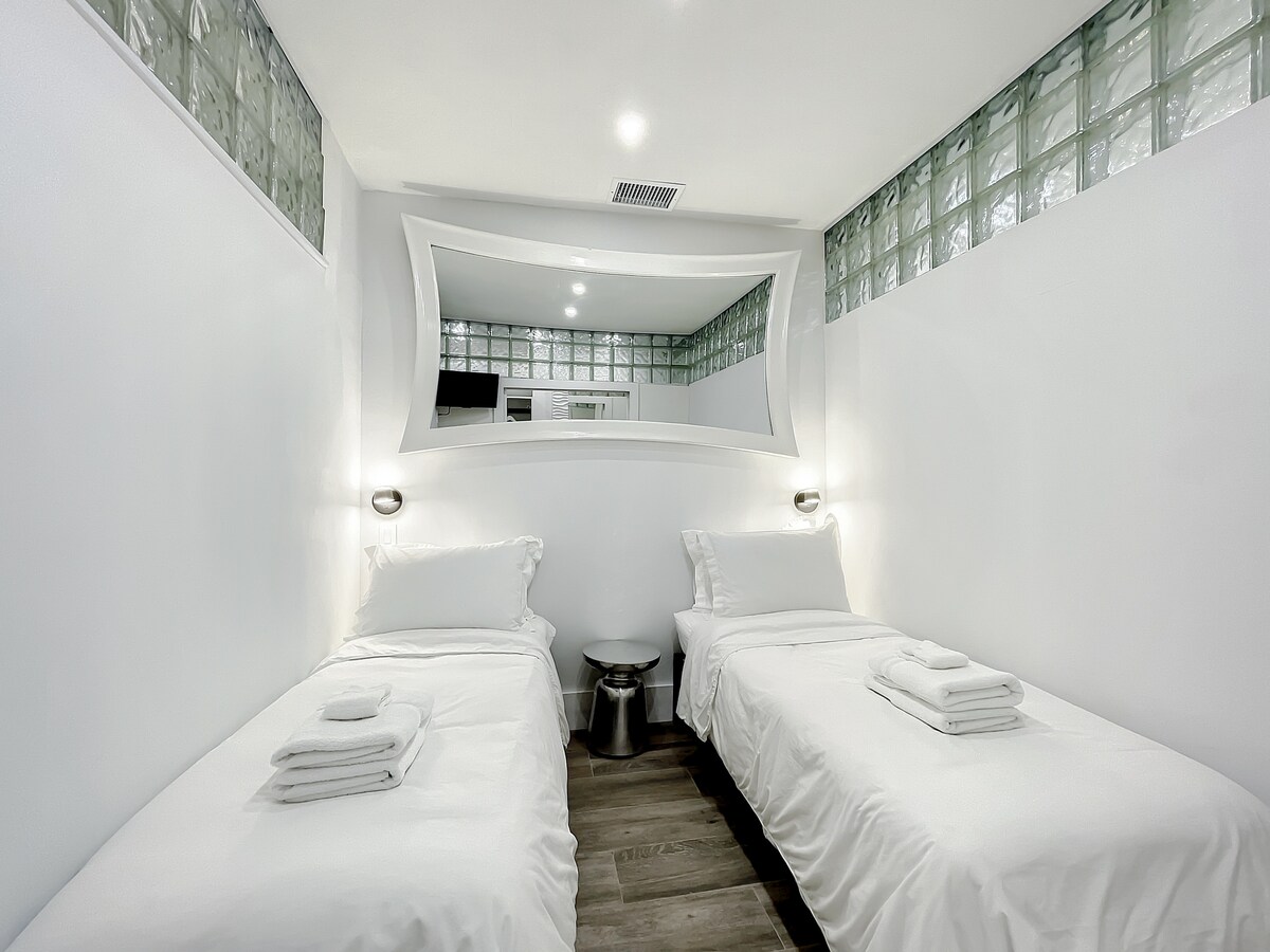 Vyumba vya kulala vyenye magodoro mazuri ya povu ya kumbukumbu, taa nzuri za mwangaza, chaja za USB, Vioo vya Designer, na muundo wa kioo wa Art Deco. 