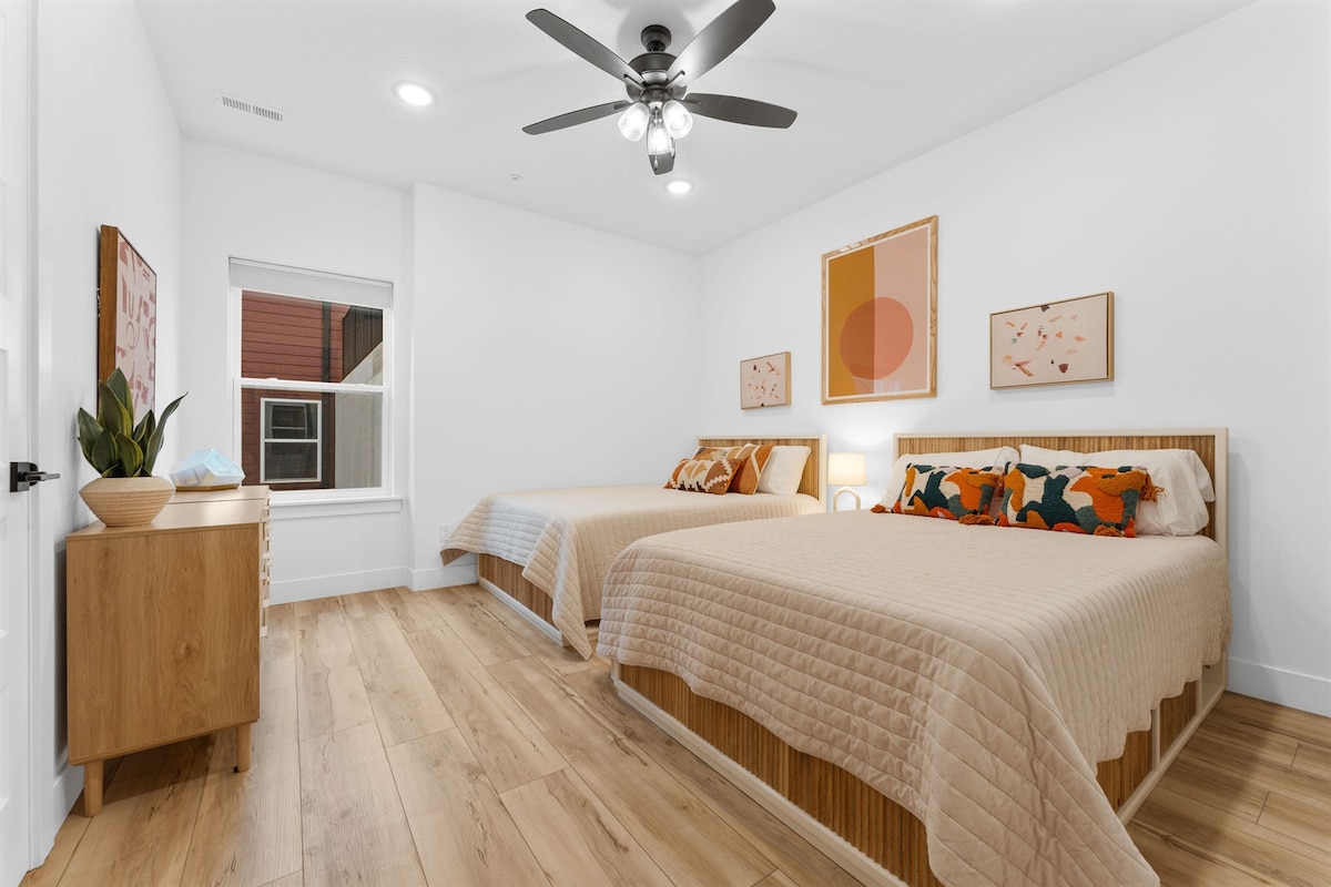 I love this room so much! Bright and fun art, two double beds, and the coolest lamp that brings a glow of rainbow into the corner