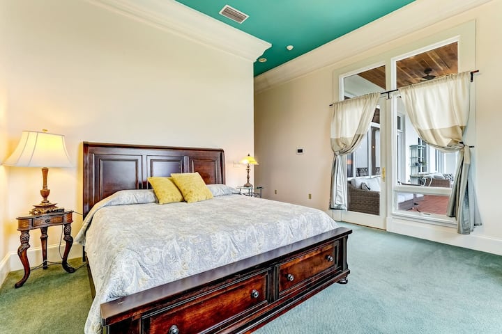 חדר שינה עם מיטת קינג ודלת למרפסת.