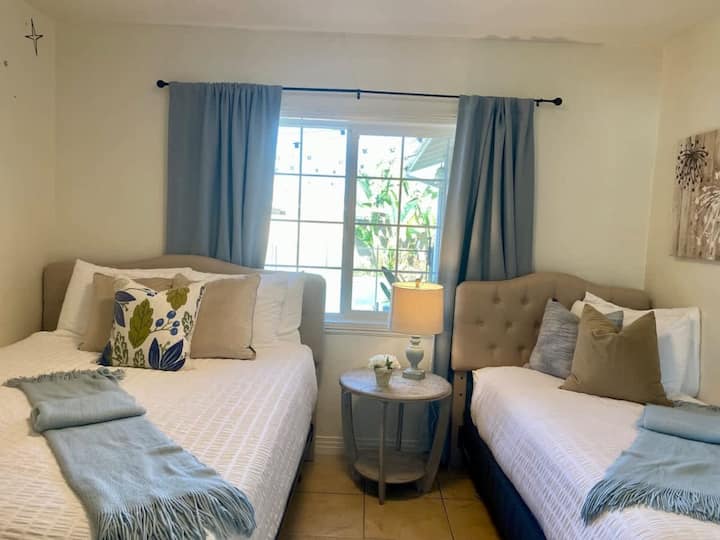 Queen and twin beds overlooking the pool 