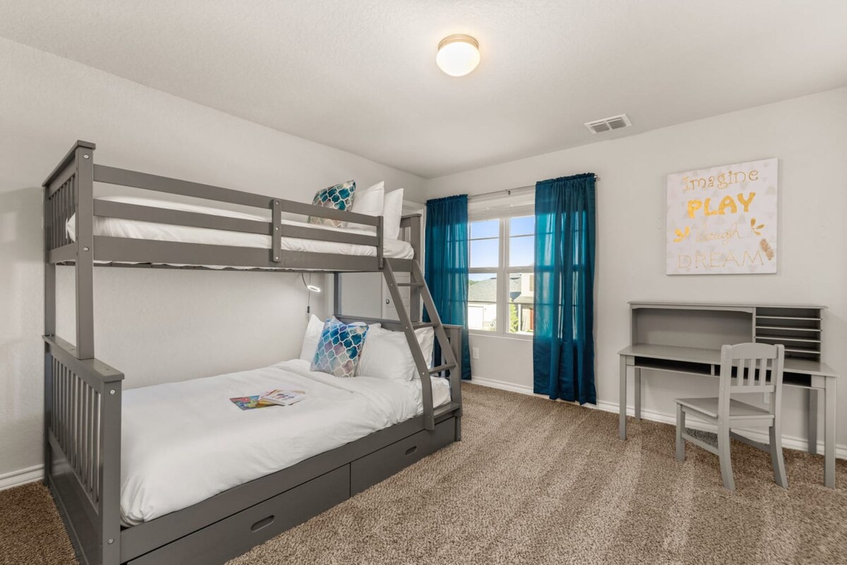 Bedroom 4: Fourth bedroom with full-size bed and twin-size bed, plus desk.