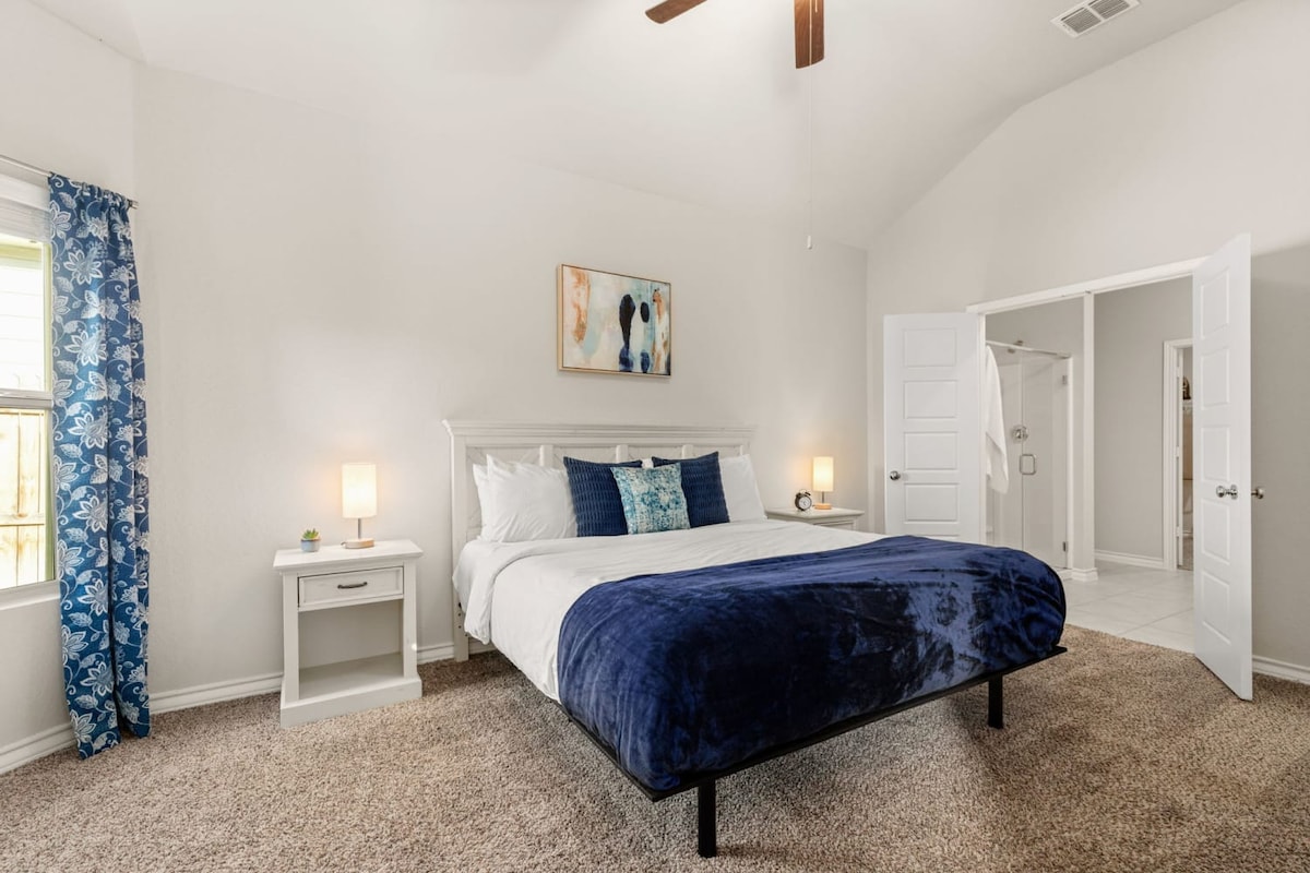 Bedroom 1: The master bedroom features a king-size bed, smart TV, and en suite bathroom.