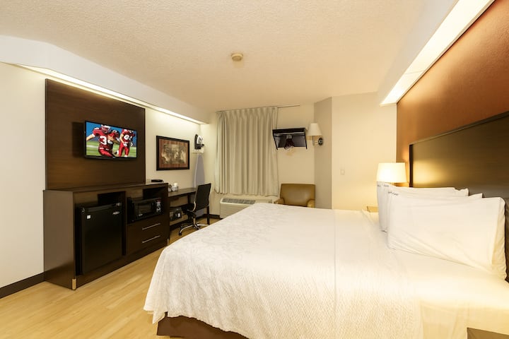 Settle into crisp comfort with plush bedding and practical workspace.