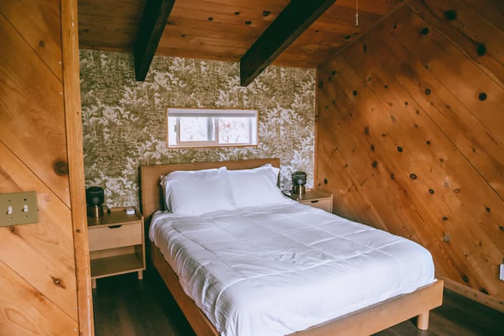 The Tower Room bedroom features fantasy wallpaper and stunning tall ceilings.