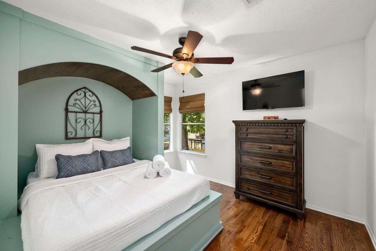 Comfortable upstairs queen bedroom with Smart TV and thoughtful décor for a relaxing night’s sleep.