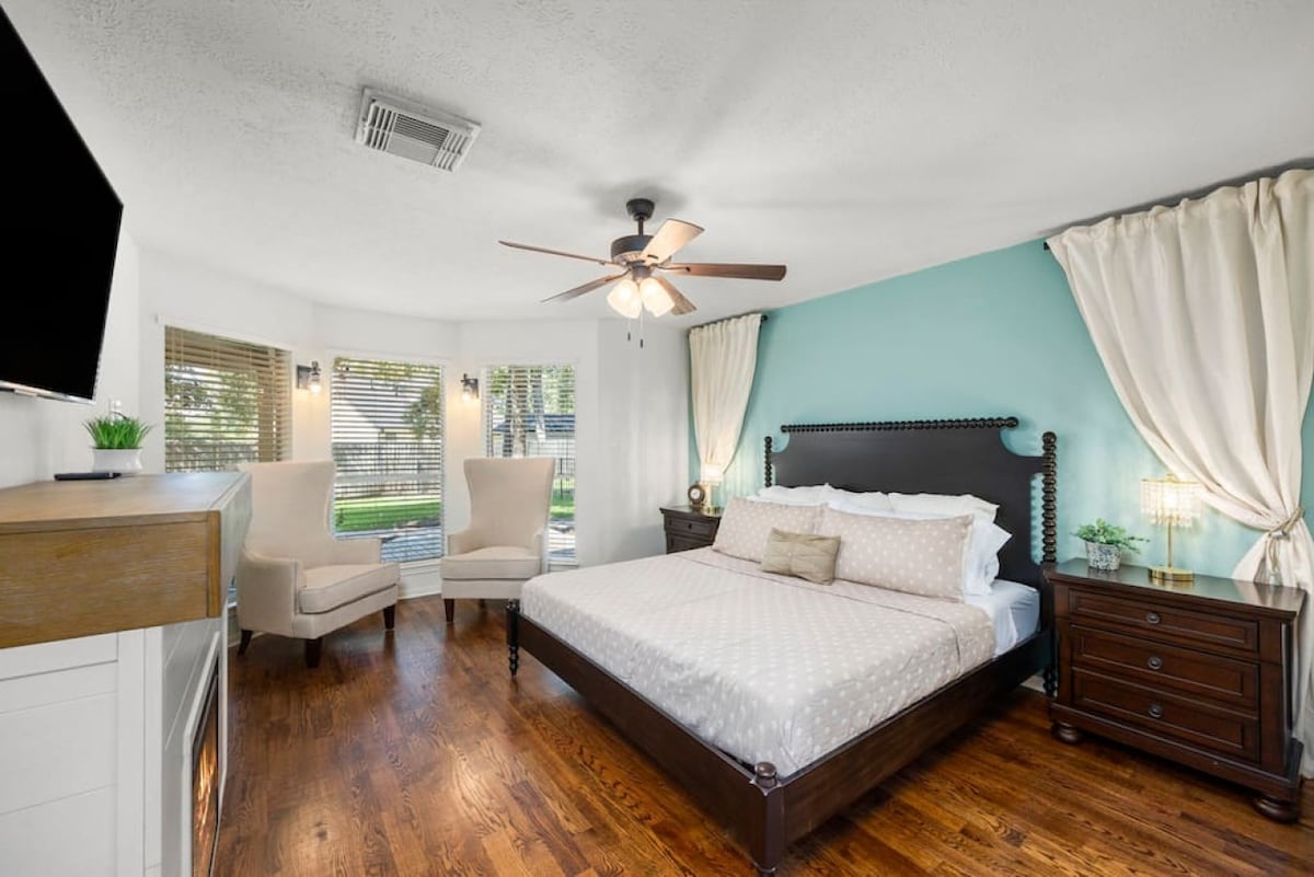 Spacious primary suite with king bed, Smart TV, and cozy reading nook — your private retreat after a full day.