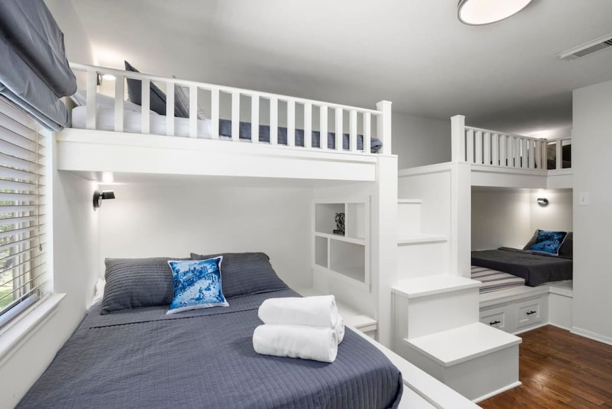 Custom built-in bunk room with multiple sleeping spaces, integrated cubbies, and storage — designed for kids, teens, and group stays.