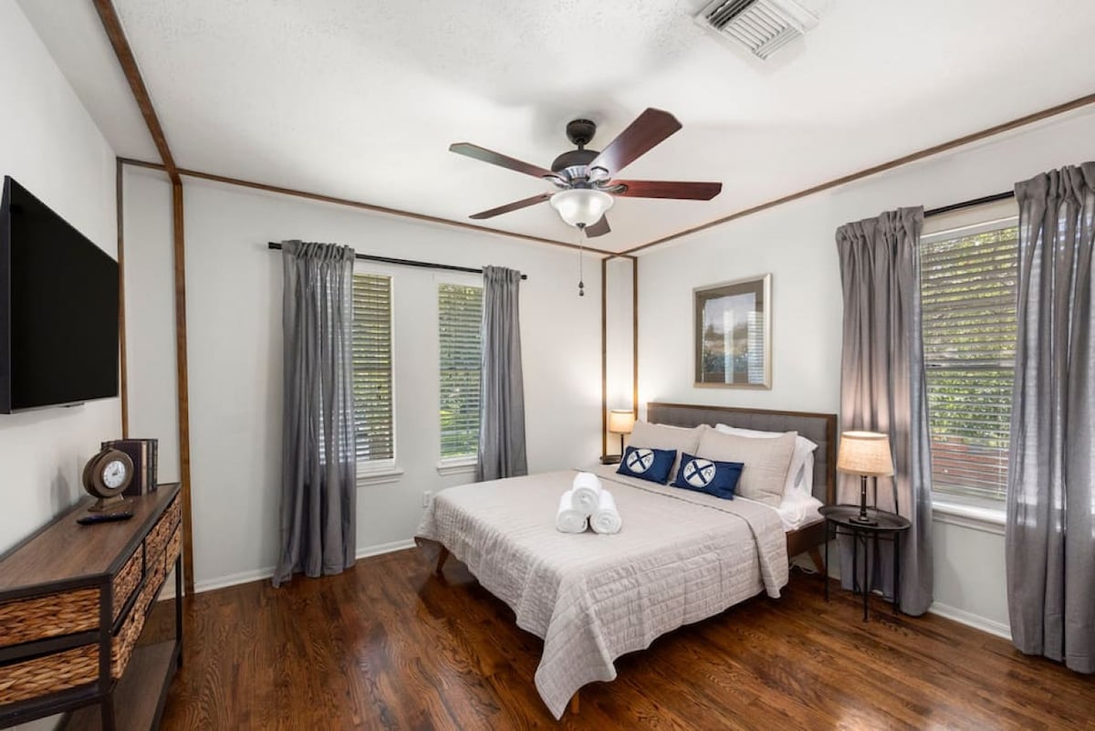 Bright upstairs queen bedroom with Smart TV — a comfortable retreat for restful nights.