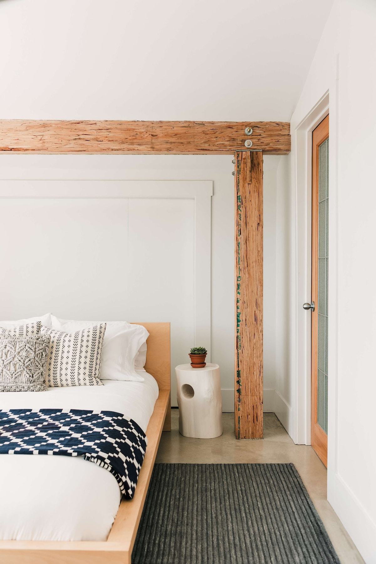 Bedroom 3 features a queen bed, full private ensuite (newly renovated) + large windows with view of front garden + living roof.