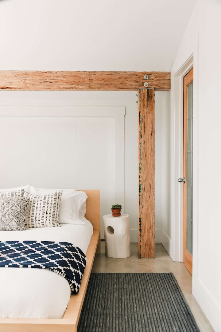 Bedroom 3 features a queen bed, full private ensuite (newly renovated) + large windows with view of front garden + living roof.