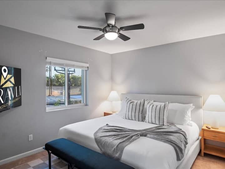Guest room with King Bed, ceiling fan and Smart TV