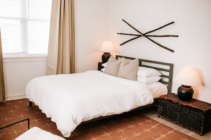 In every bedroom, you'll find a queen-sized Purple Mattress accompanied by organic Supima cotton linens and a duvet. Rest assured that each element of bedding, including throw pillows and blankets, undergoes meticulous sanitization between every gues