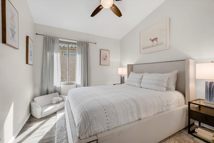 Experience serenity in our Serenity Bedroom, featuring a cozy queen-sized bed and carefully selected neutral decor for a soothing vibe. It's a tranquil haven designed for relaxation and comfort.