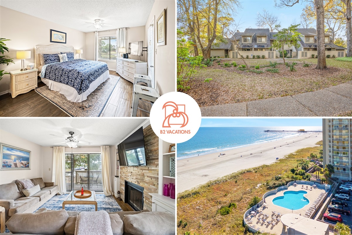A cozy bedroom features a spacious bed with a soft blue coverlet, a nightstand, and a large window letting in natural light. The living area showcases a comfortable sofa and a flat-screen TV on a stone fireplace. Outdoor views of the beach and pool are highlighted.
