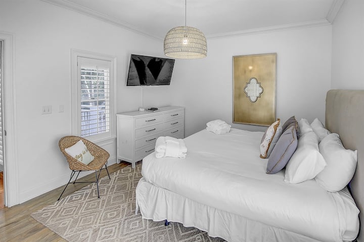 Second Floor King Bedroom - Indulge in comfort in our second-floor bedroom adorned with a luxurious king bed and a private bathroom. There is a dresser, closet and large mounted tv.