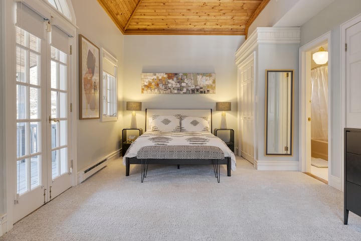 Primary bedroom in the main house features a queen bed, TV, and ensuite bathroom.