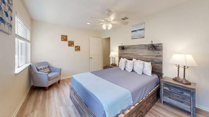 Comfortable king bedroom with ceiling fan and soft linens, ideal for recharging after full Spring Break days on the river, exploring Gruene shops, or enjoying live music nearby.
