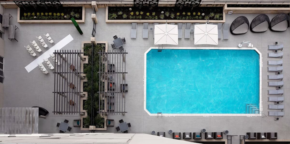 Close to UT Austin + Pool. Bar. Free Breakfast.