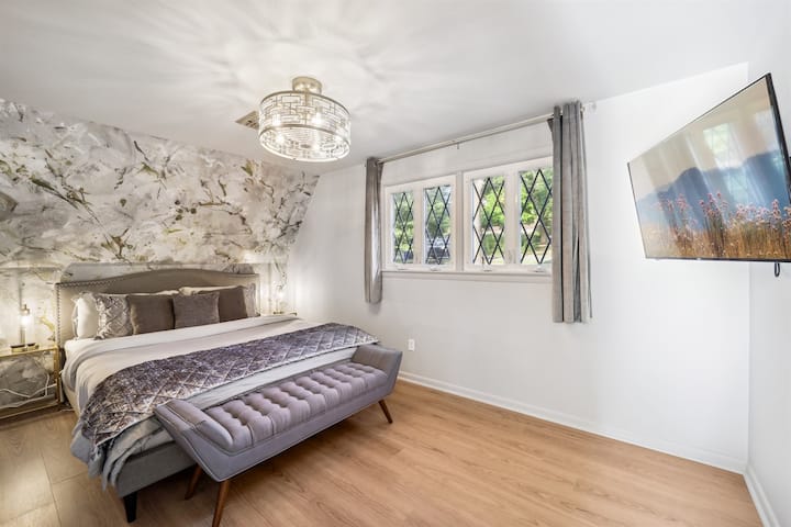 Enjoy your rest in this sophisticated modern bedroom with gold accents and a Cal King bed on the main level