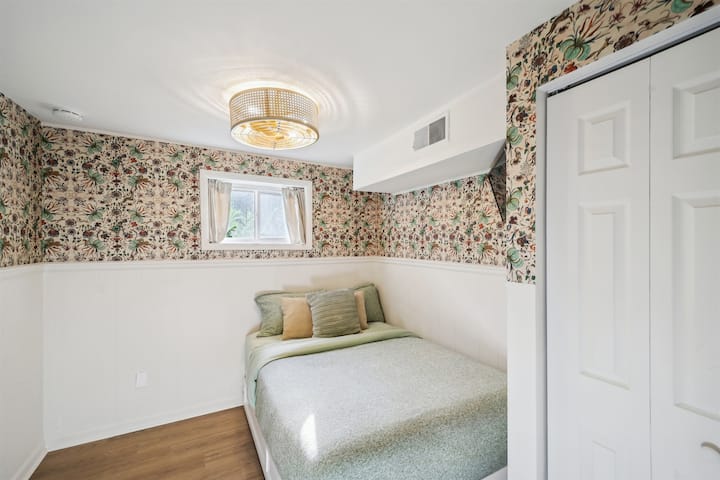 Enjoy the whimsical wall paper and beautiful morning light in this room in the basement level