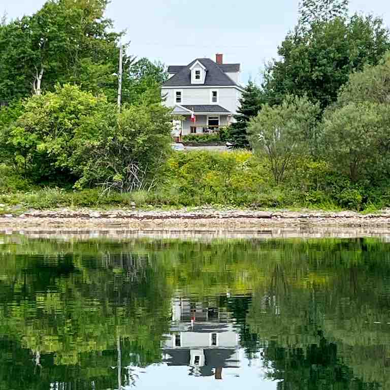 Waterfront homestead on 4 landscaped acres.