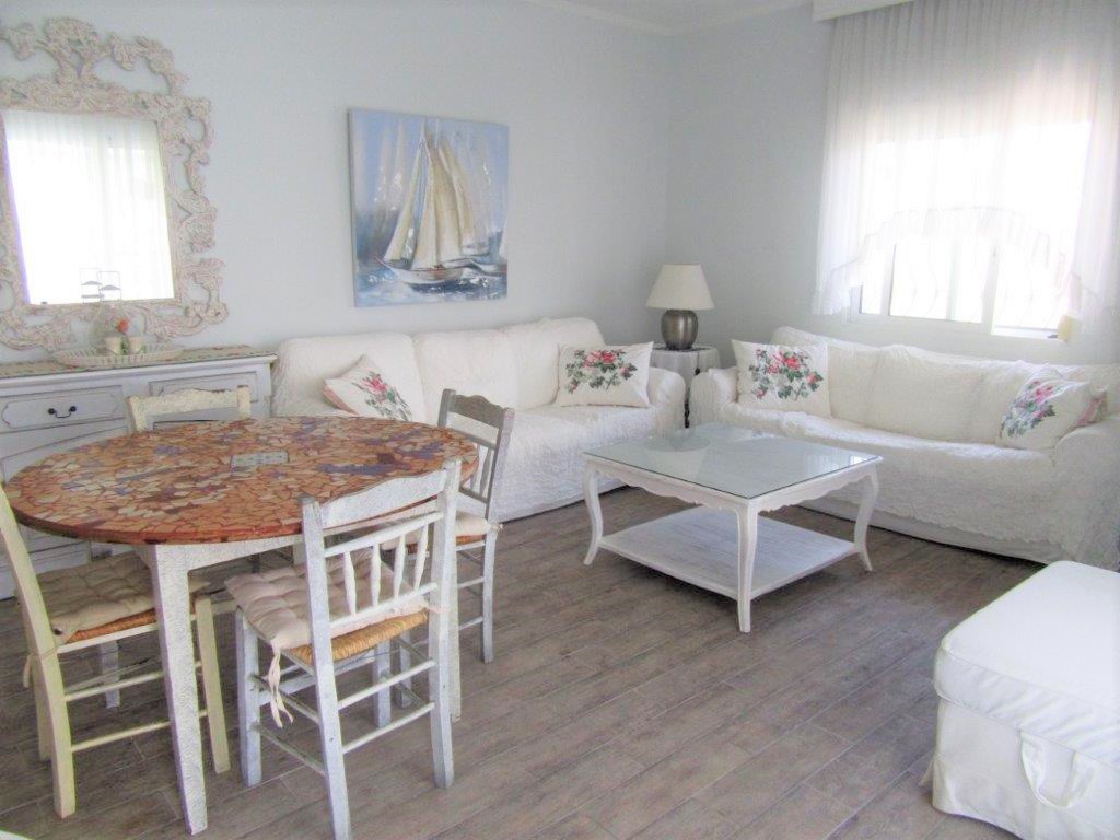 Pefkochori apartment with yard and indoor parking.