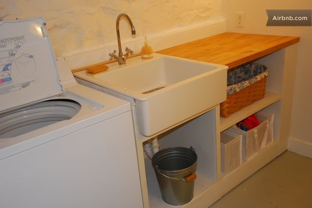 ... room with washer and dryer, iron, ironing board and utility sink