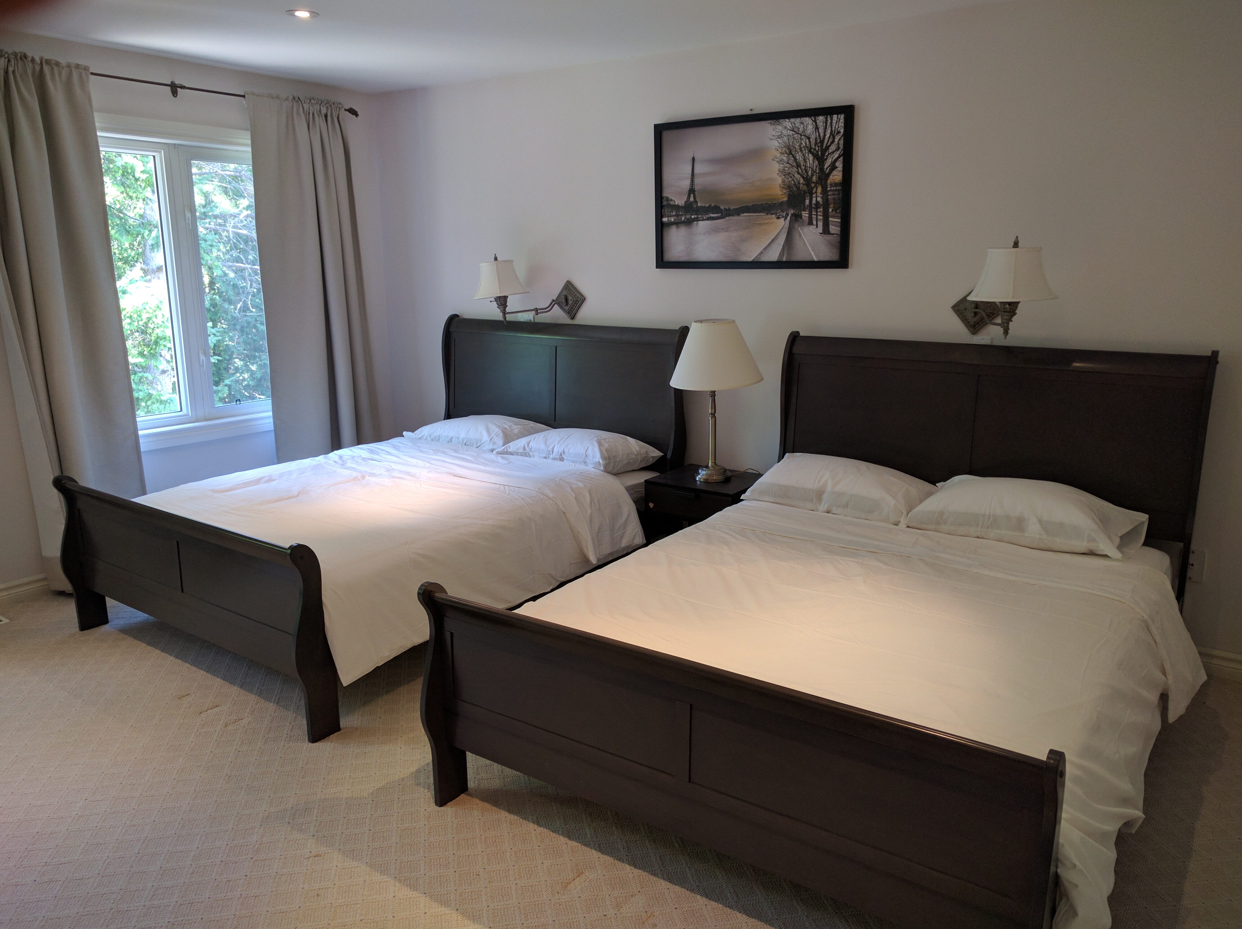Two queen beds with a private bathroom by subway