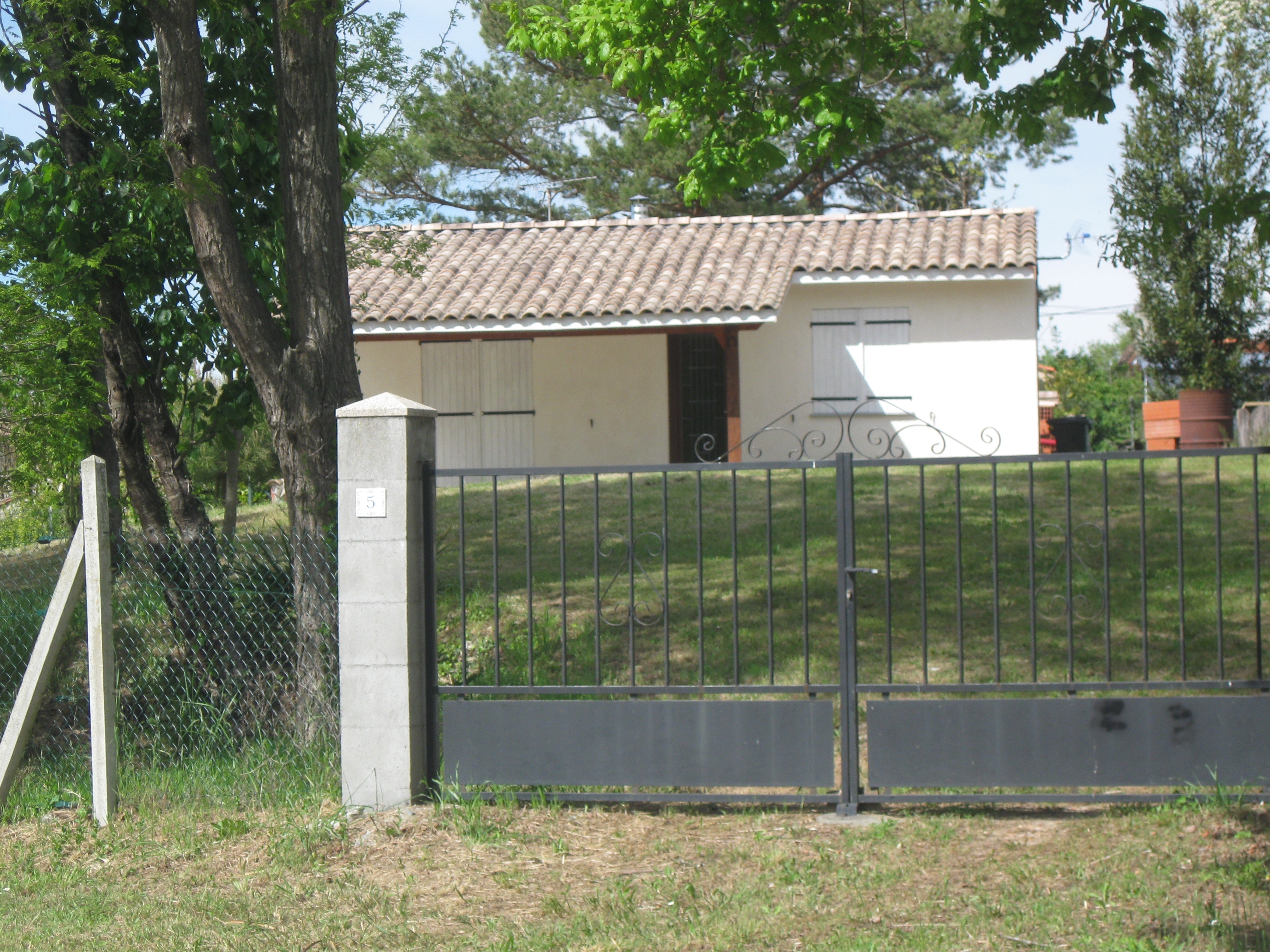 Small single-storey house with fenced land