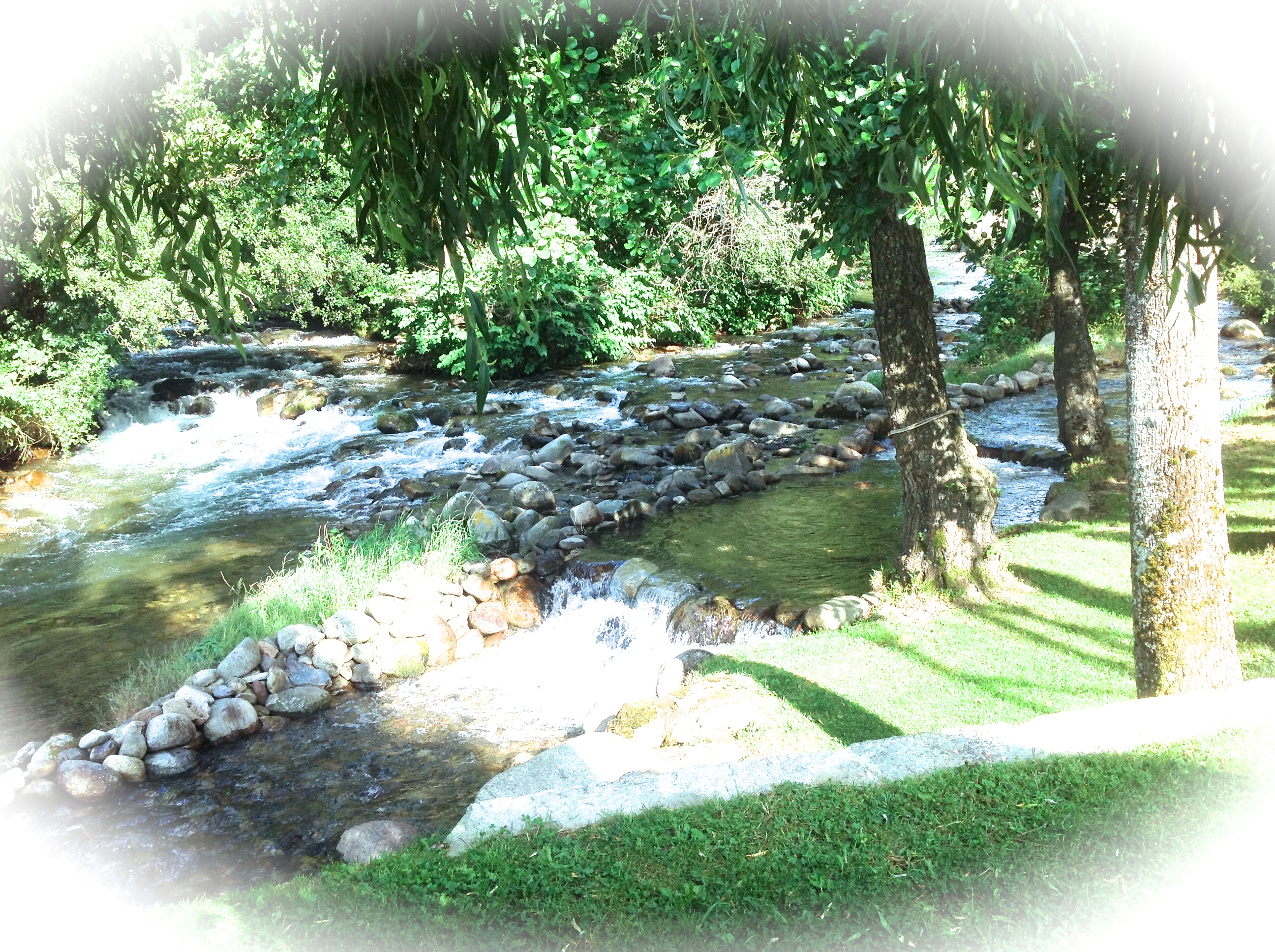 Mountain lodge nestled by a river ***