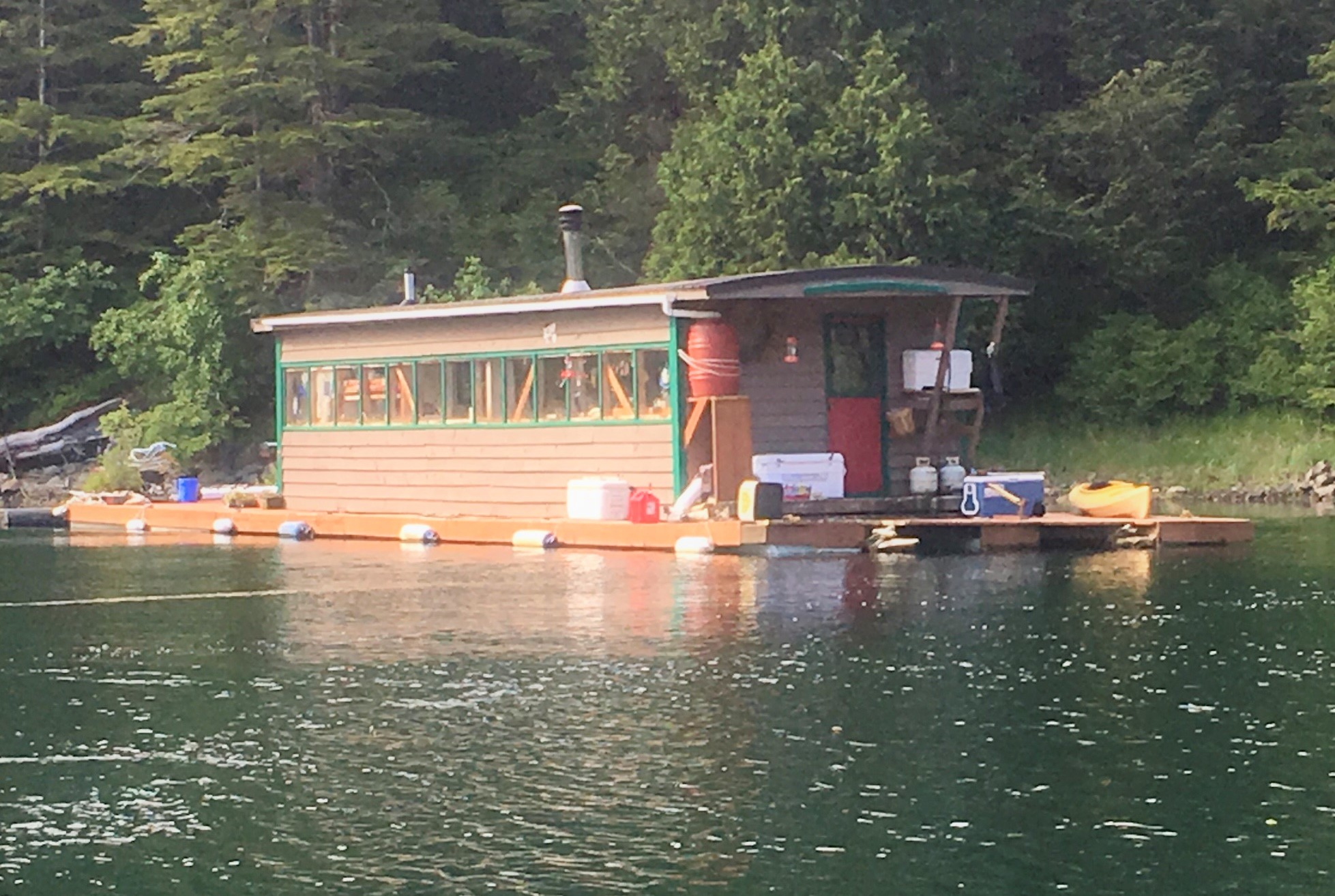 The Caboose, secluded float house in calm waters.