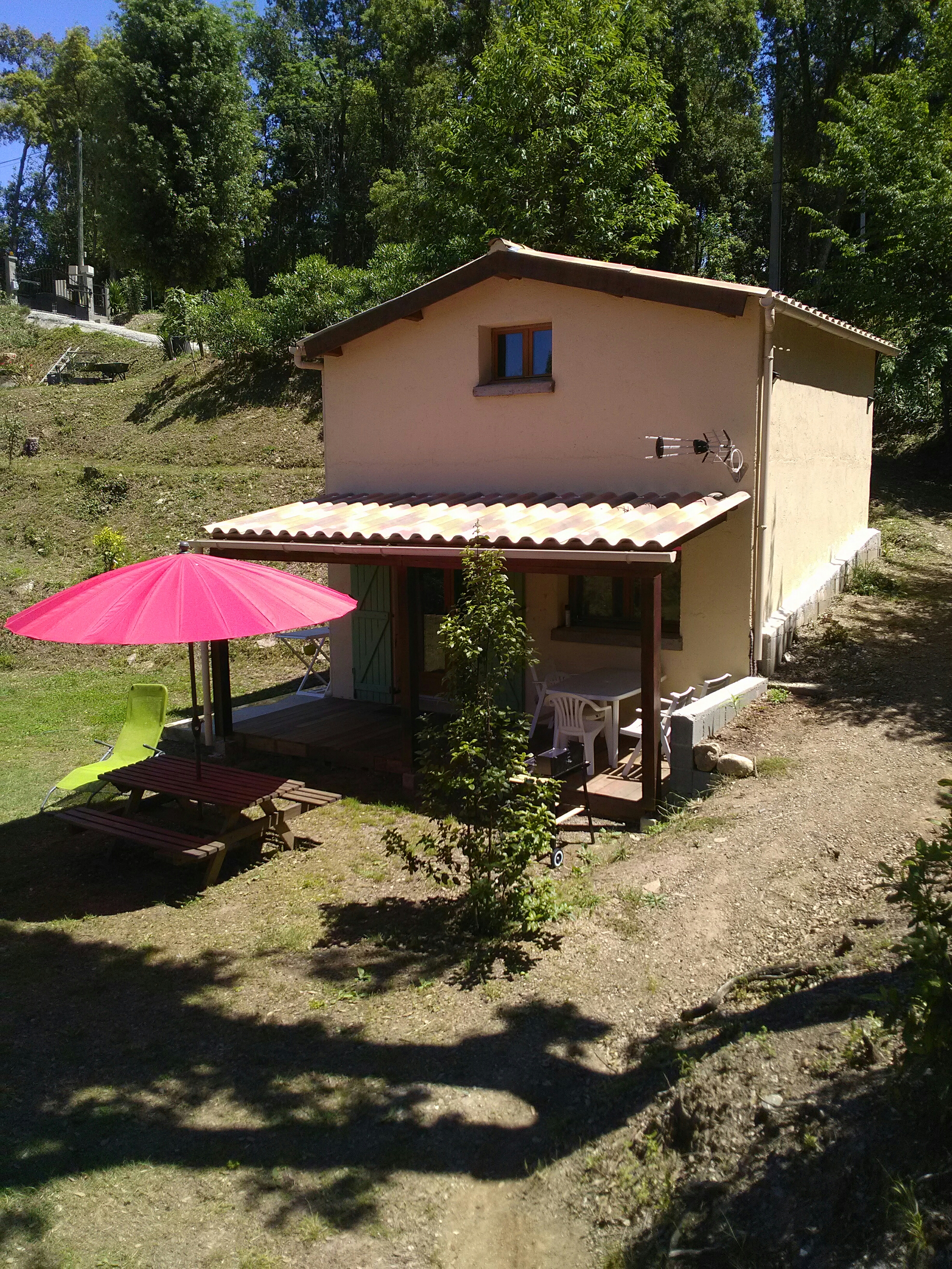 small house between sea and mountain