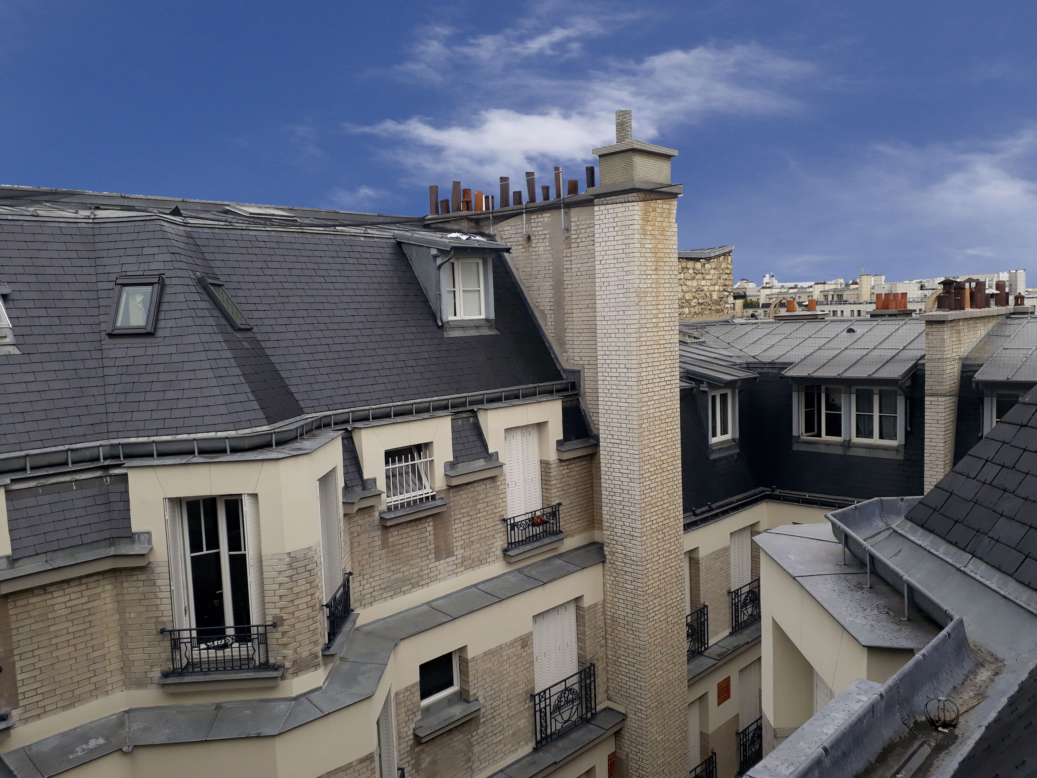 The rooftops of Paris near Batignolles mobility lease Airbnb