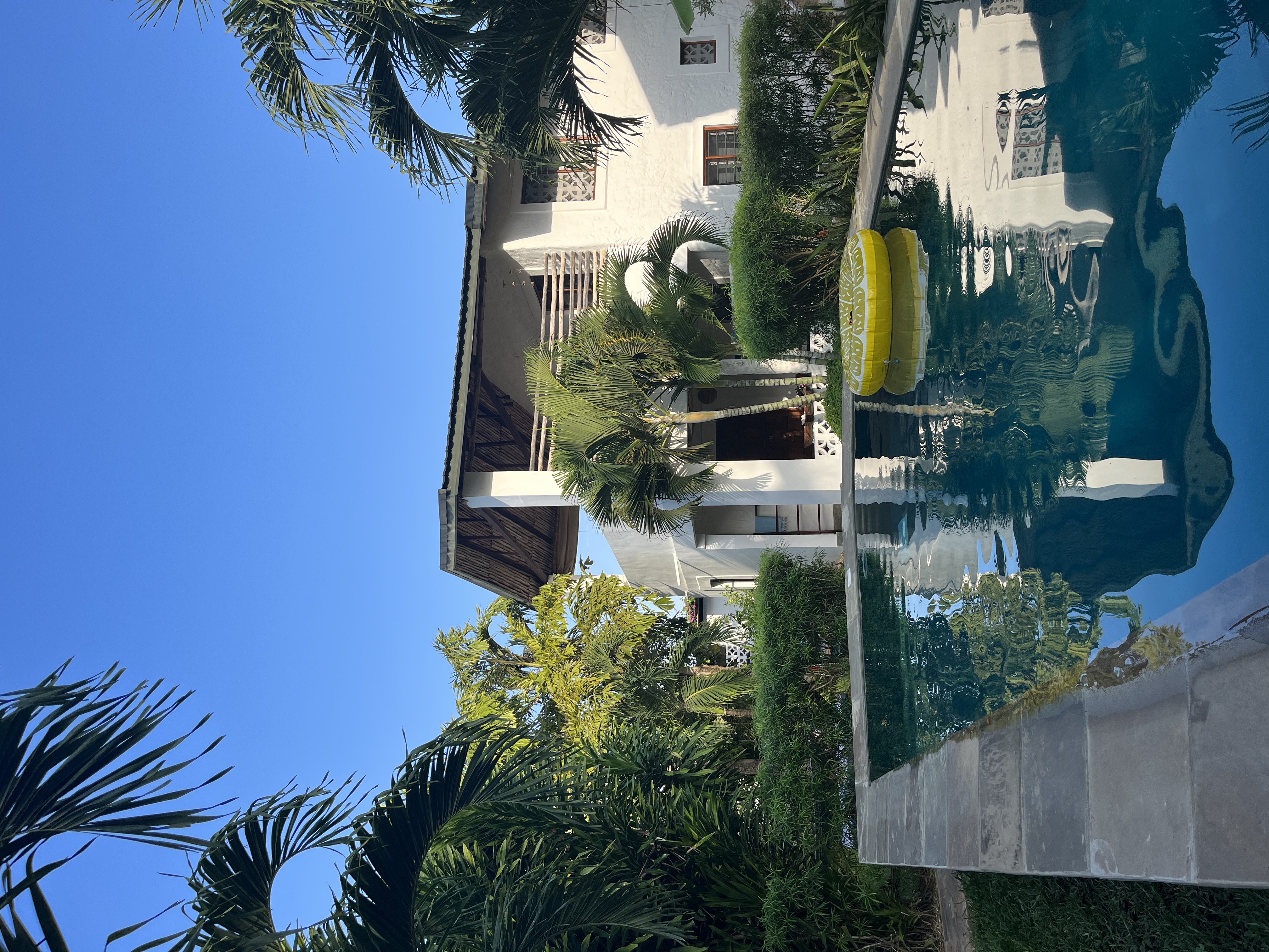 Spacious apartment 1 with lush garden and pool.