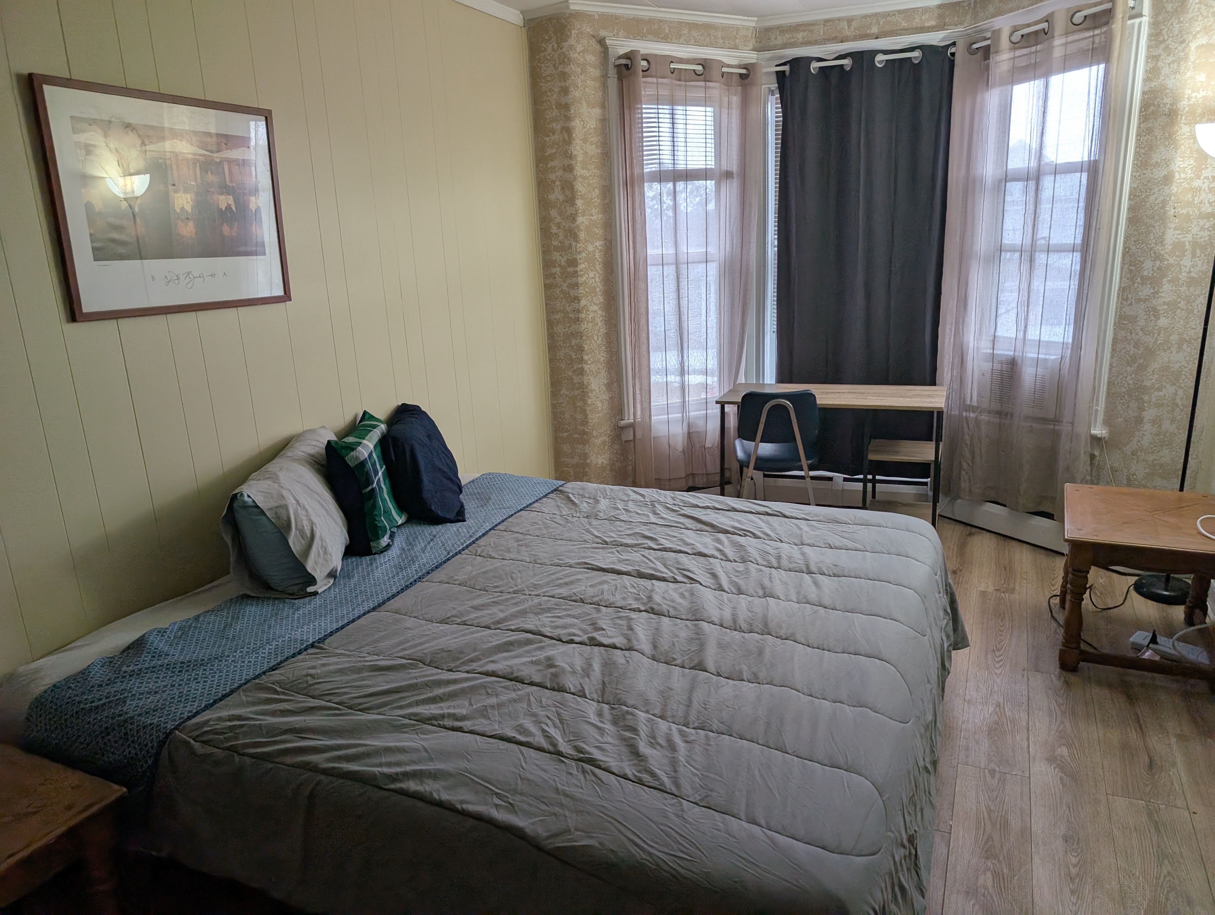 The front room w/ TV and king size bed in THIRTEENTH WARD, Albany