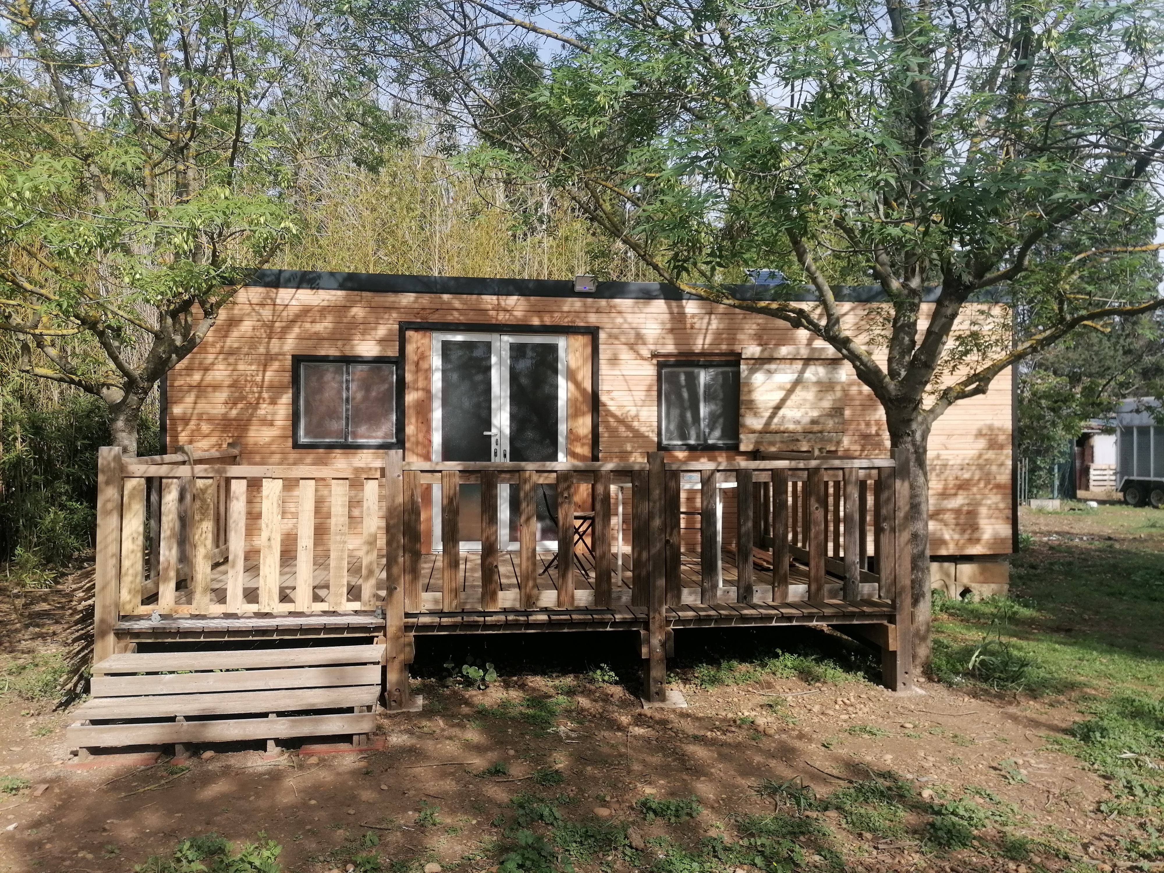 Shaded mobile home studio in the countryside