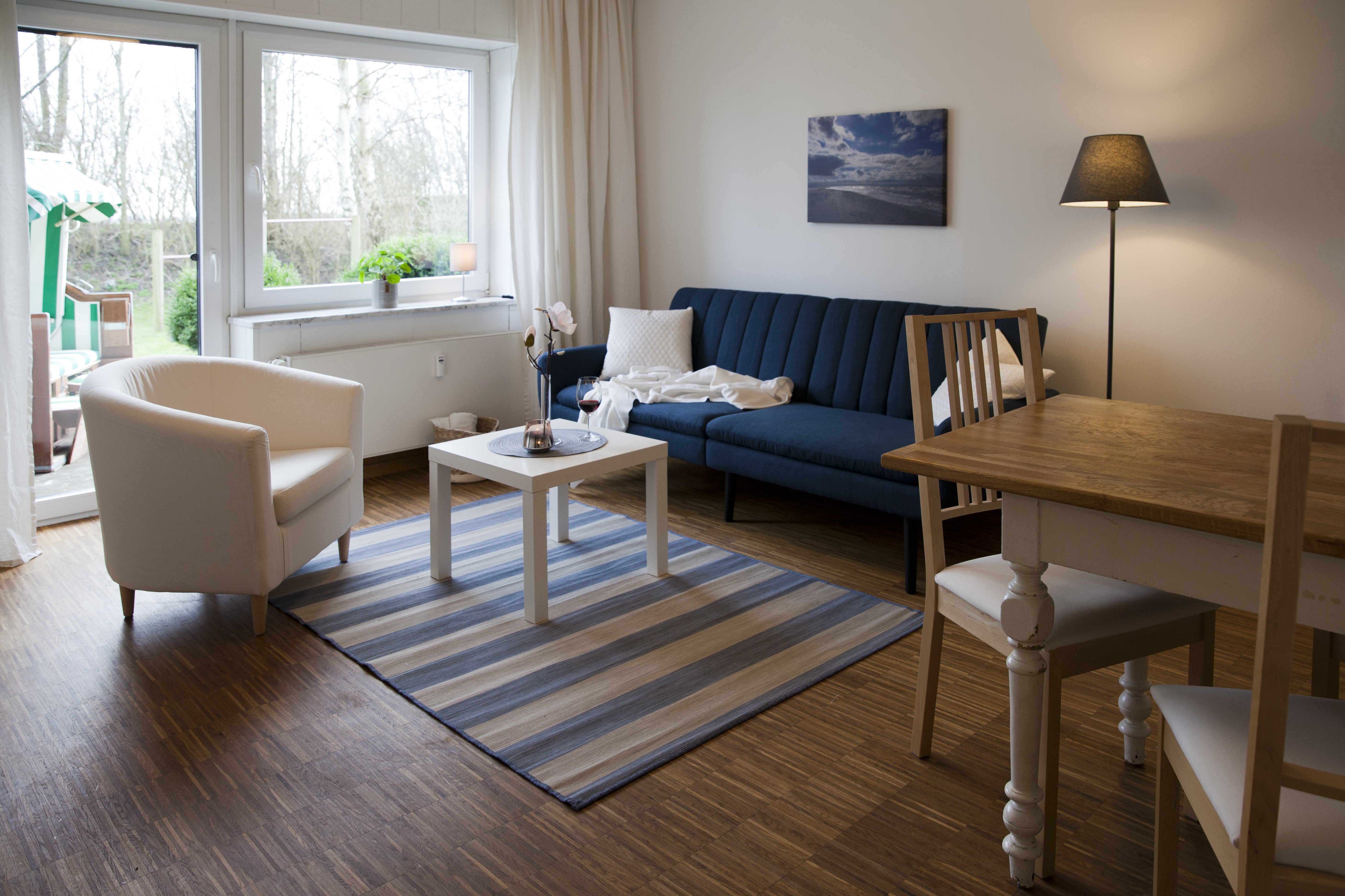 Apartment with sunny wooden terrace and beach chair
