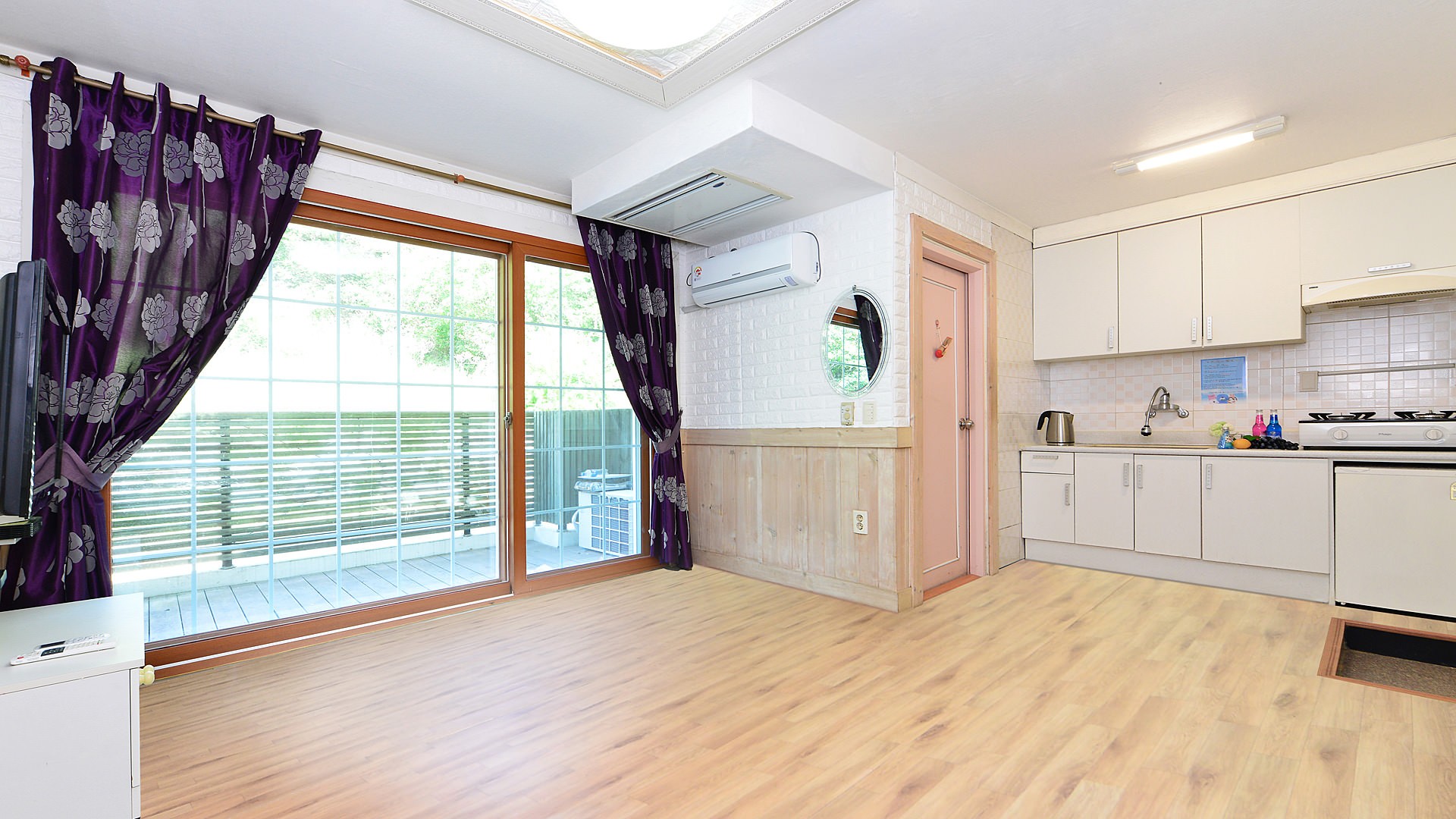 Room 206 Family Ondol Room (White) in a house with gardens full of trees and flowers